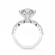 White Gold Round Shape Diamond Side Stone Engagement Ring With Shared Prong Setting.